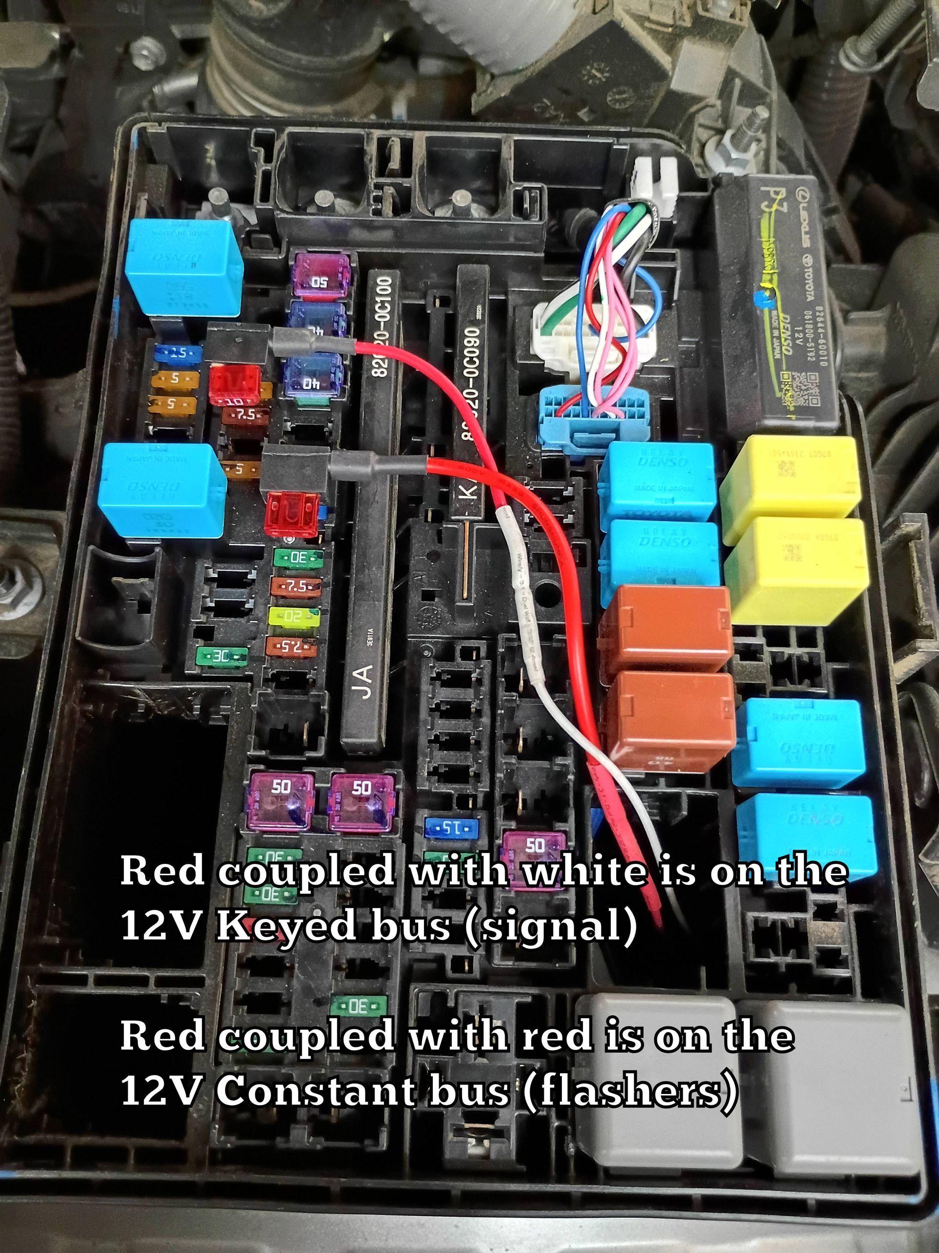 Car fuse/relay box with red and white wires connected, labeled wiring setup for 12V keyed and constant power.
