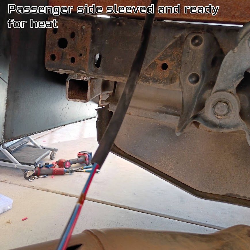 Undercarriage of a car with passenger side sleeved and ready for heat, tools on the floor below.