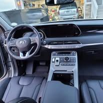 Hyundai car interior with steering wheel, dashboard, center console, and front seats visible