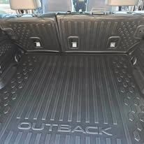 Subaru Outback cargo area with black rubber trunk liner and folded rear seats