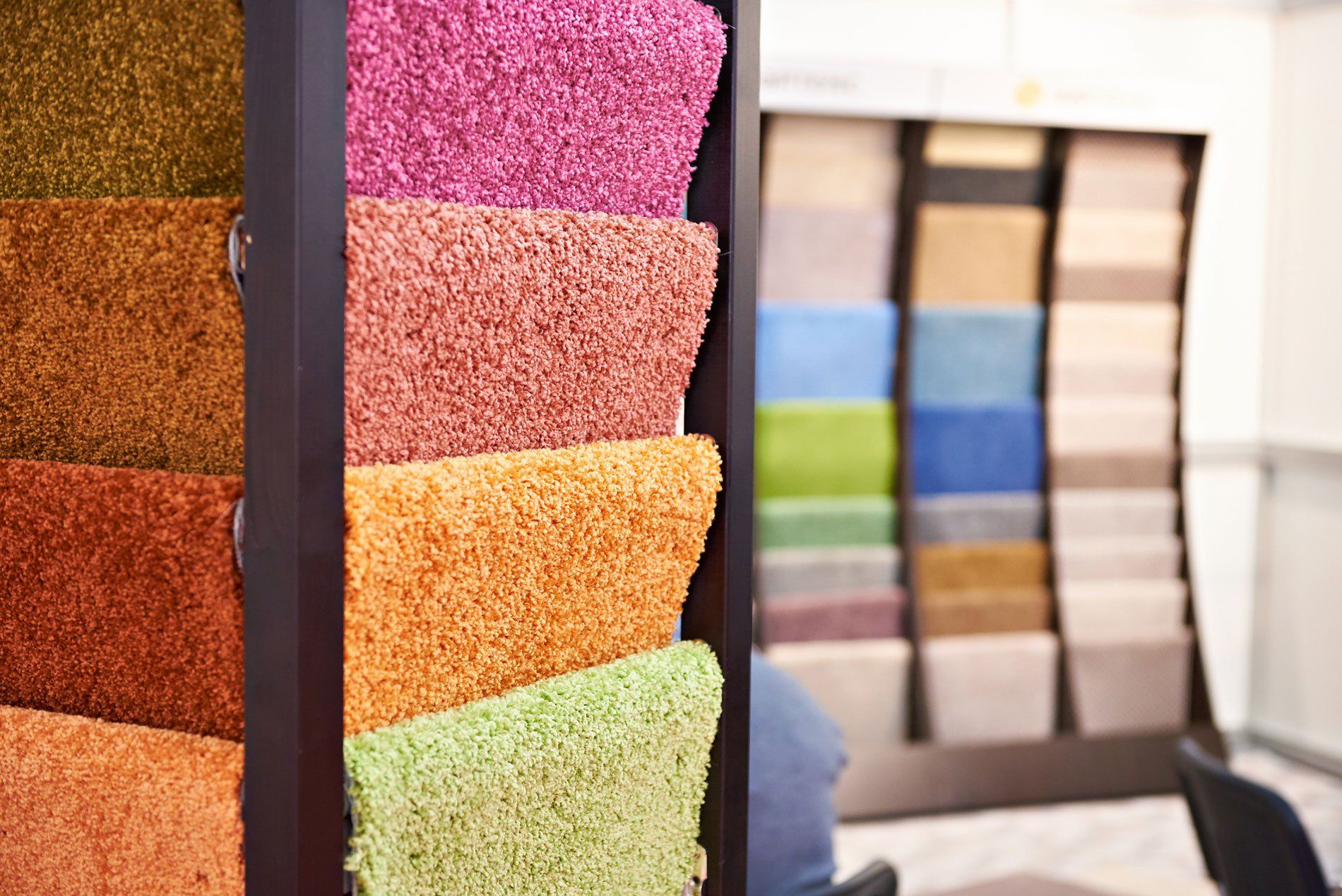 a display of different colored carpets in a store