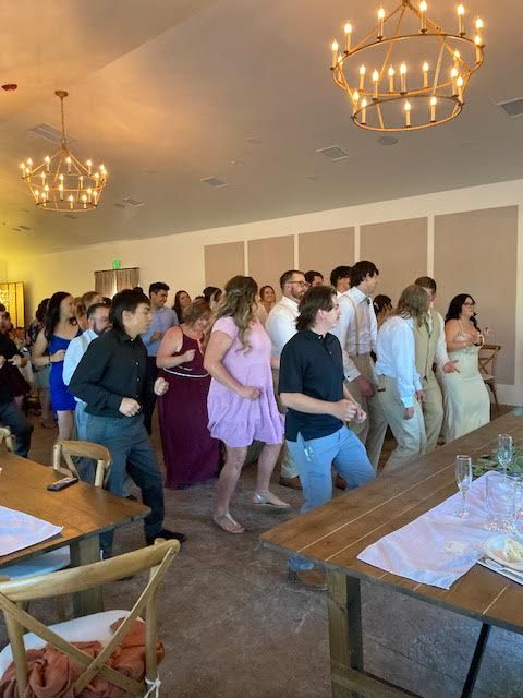 A large group of people are dancing in a room.