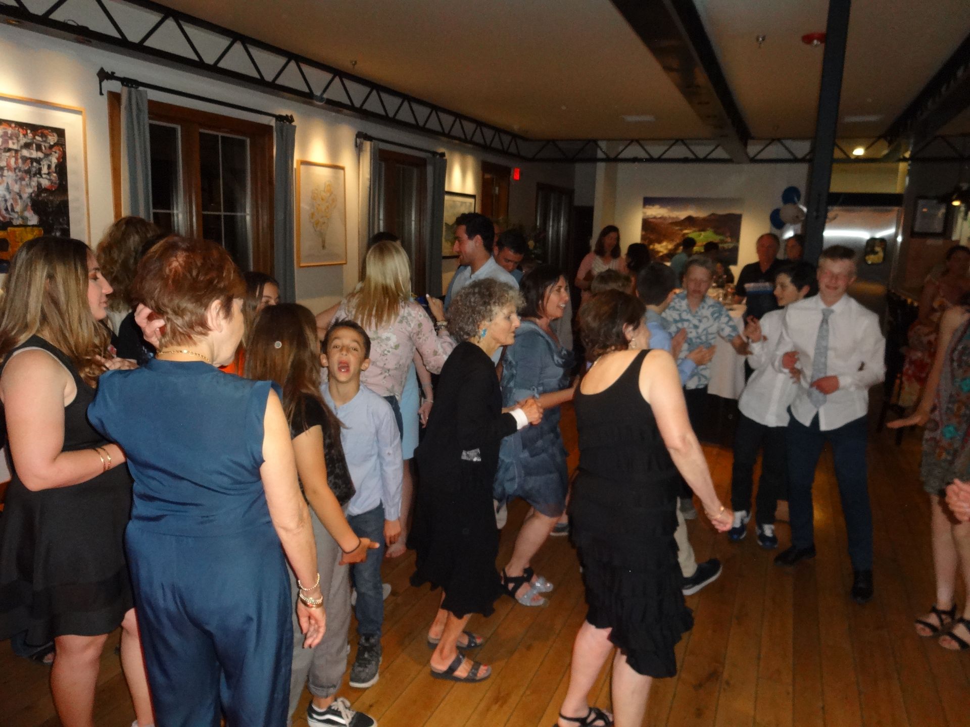 A large group of people are dancing in a room.