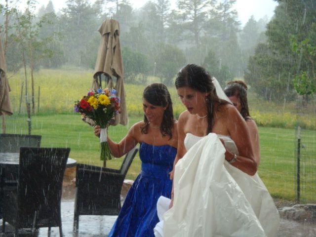 A bride and her bridesmaids are walking in the rain