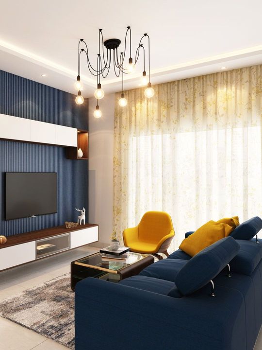 A living room with a blue couch and a yellow chair