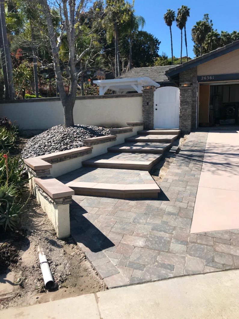 A house with a driveway and stairs leading up to it