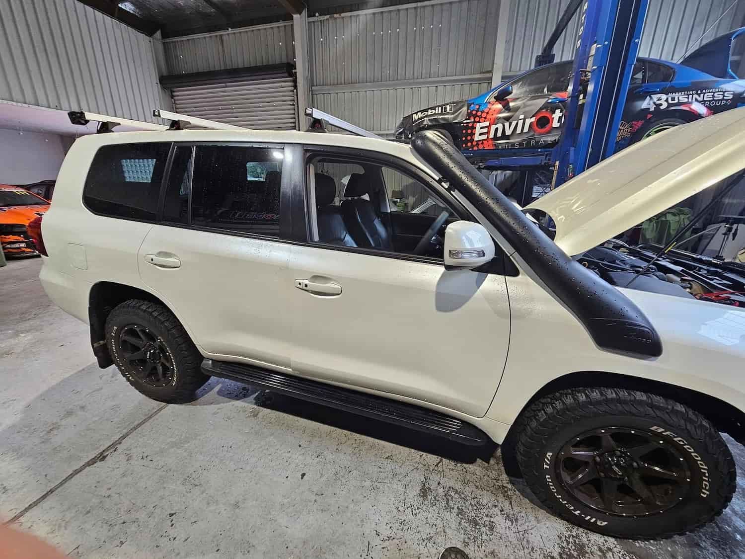 A White Suv With The Hood Up Is Parked In A Garage — Suncoast Mechanical In Nambour, QLD