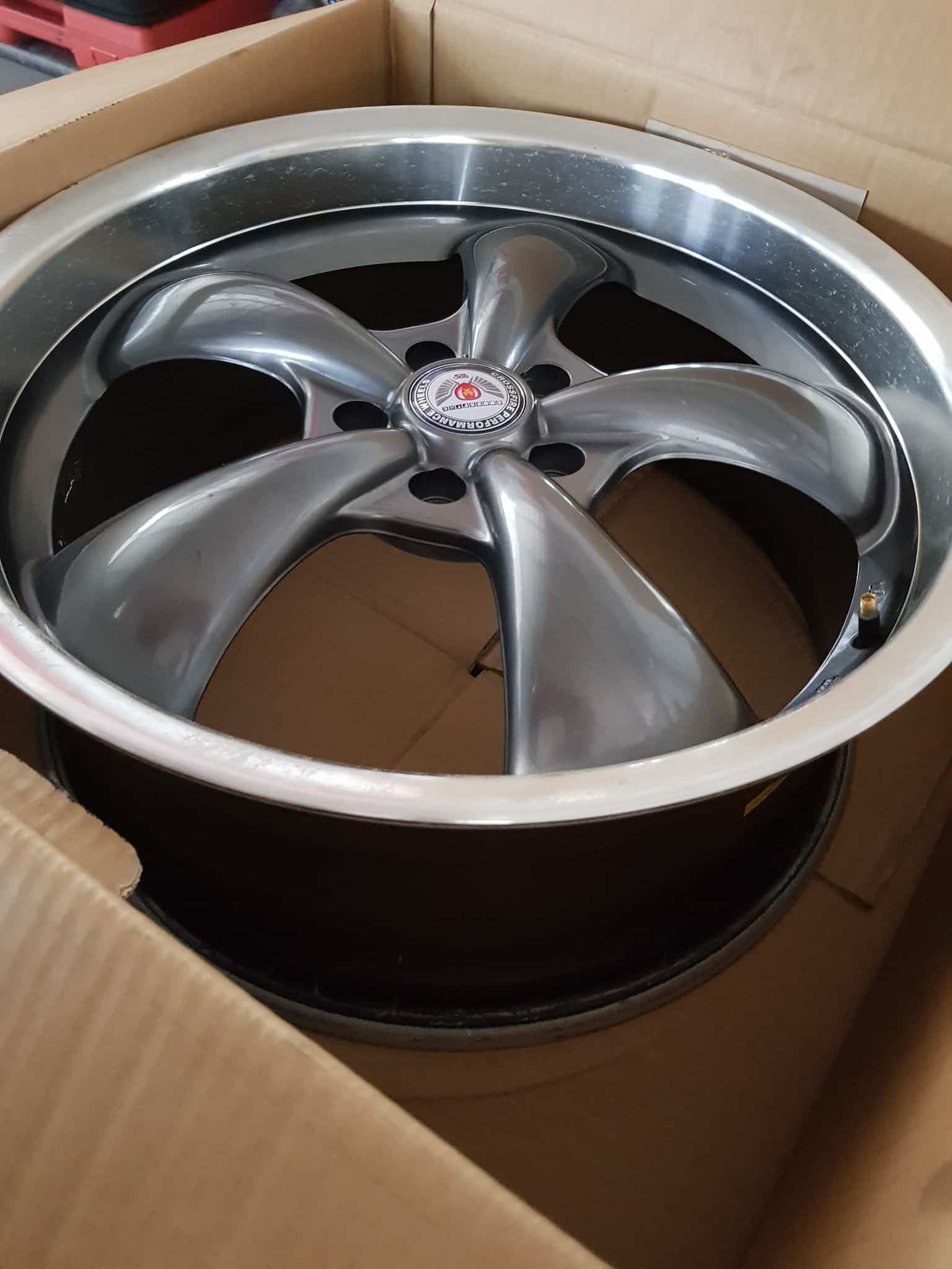 A Car Wheel Is Sitting In A Cardboard Box — Suncoast Mechanical In Nambour, QLD