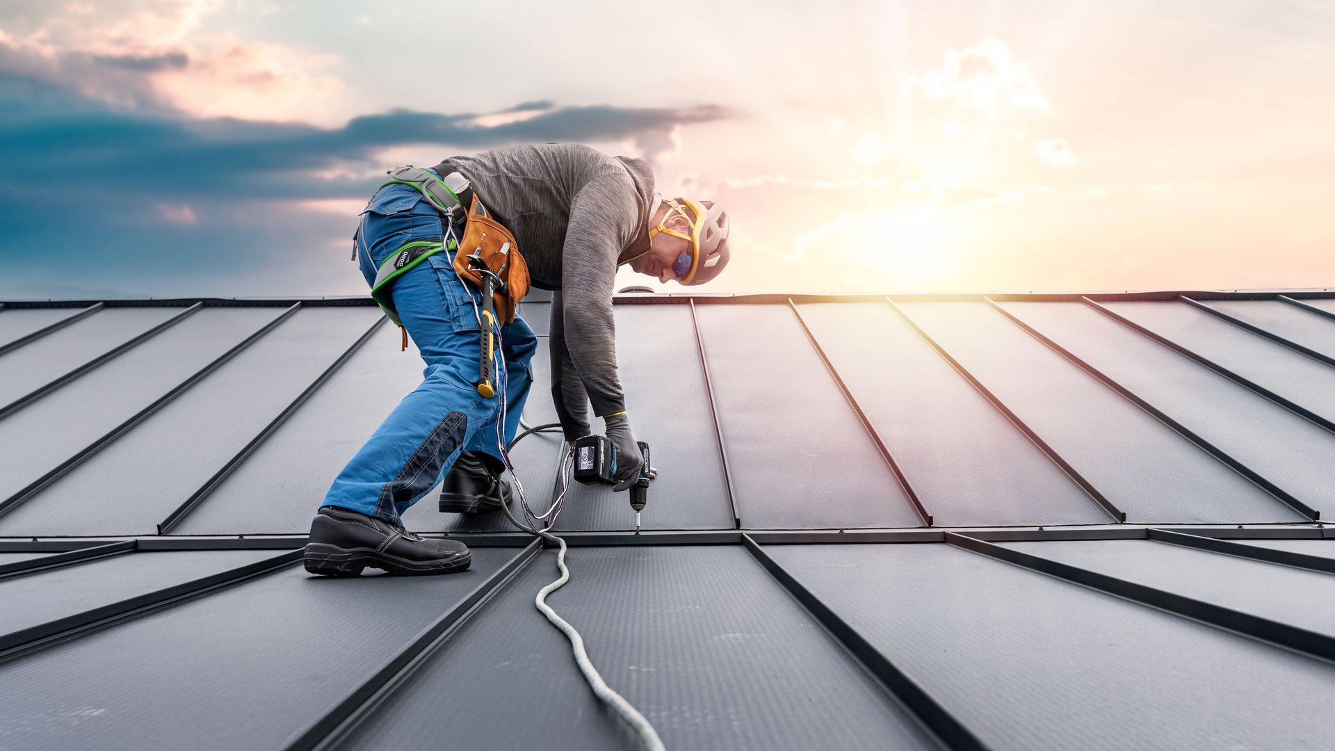A roof repair contractor is performing roof repair services on a house.