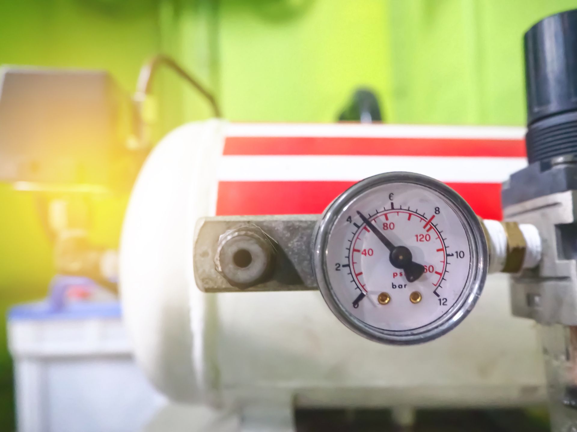 Close-up of a pressure gauge on an air compressor tank