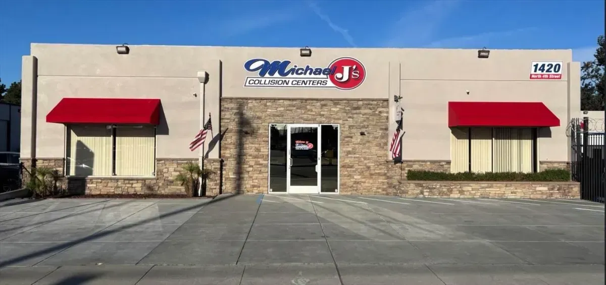 Michael J's Furniture building with red awnings and stone accent; American flags and sunny sky.