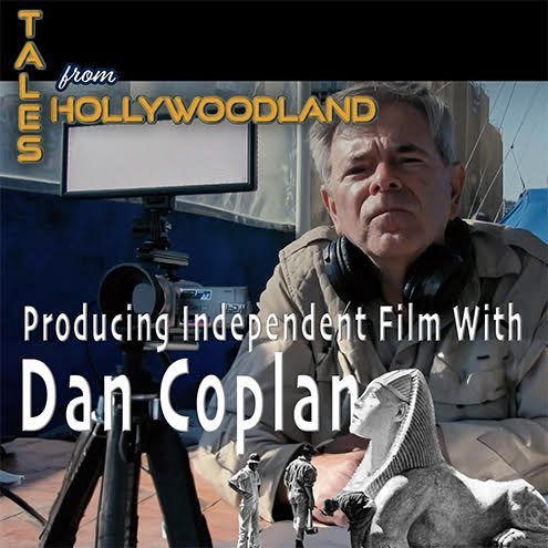 A man is sitting in front of a camera with the words