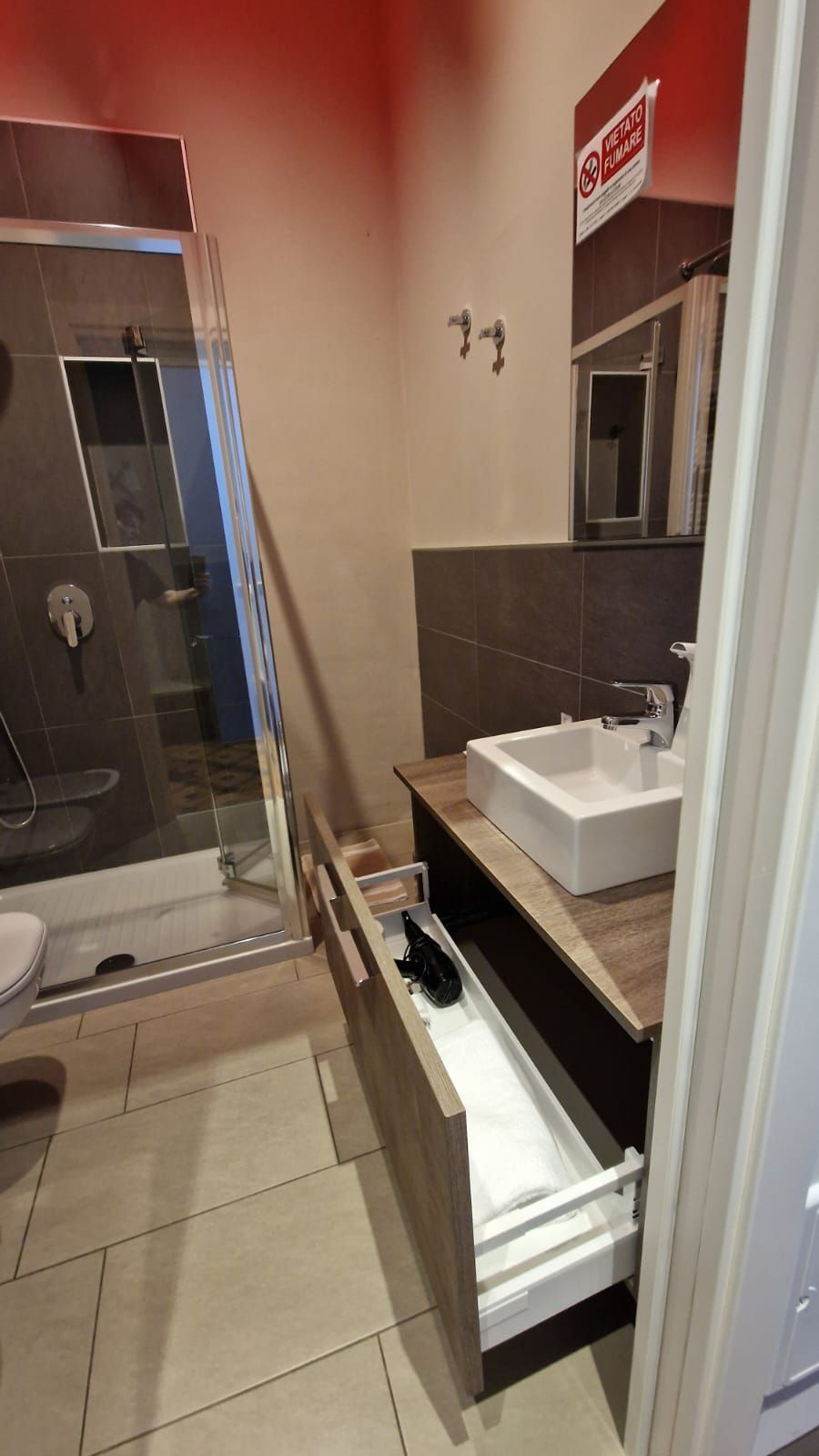 bagno con lavandino e cassettone aperto.