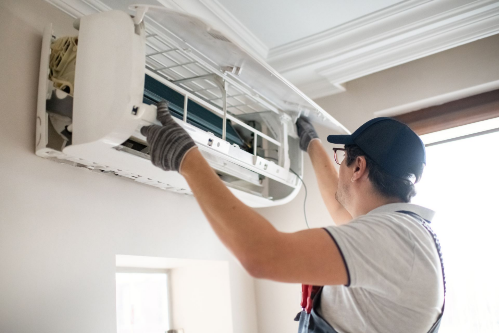 An expert technician repairing an air conditioner at home