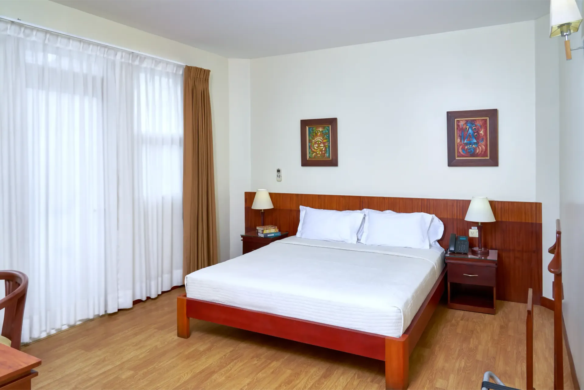 A hotel room with a large bed and two nightstands