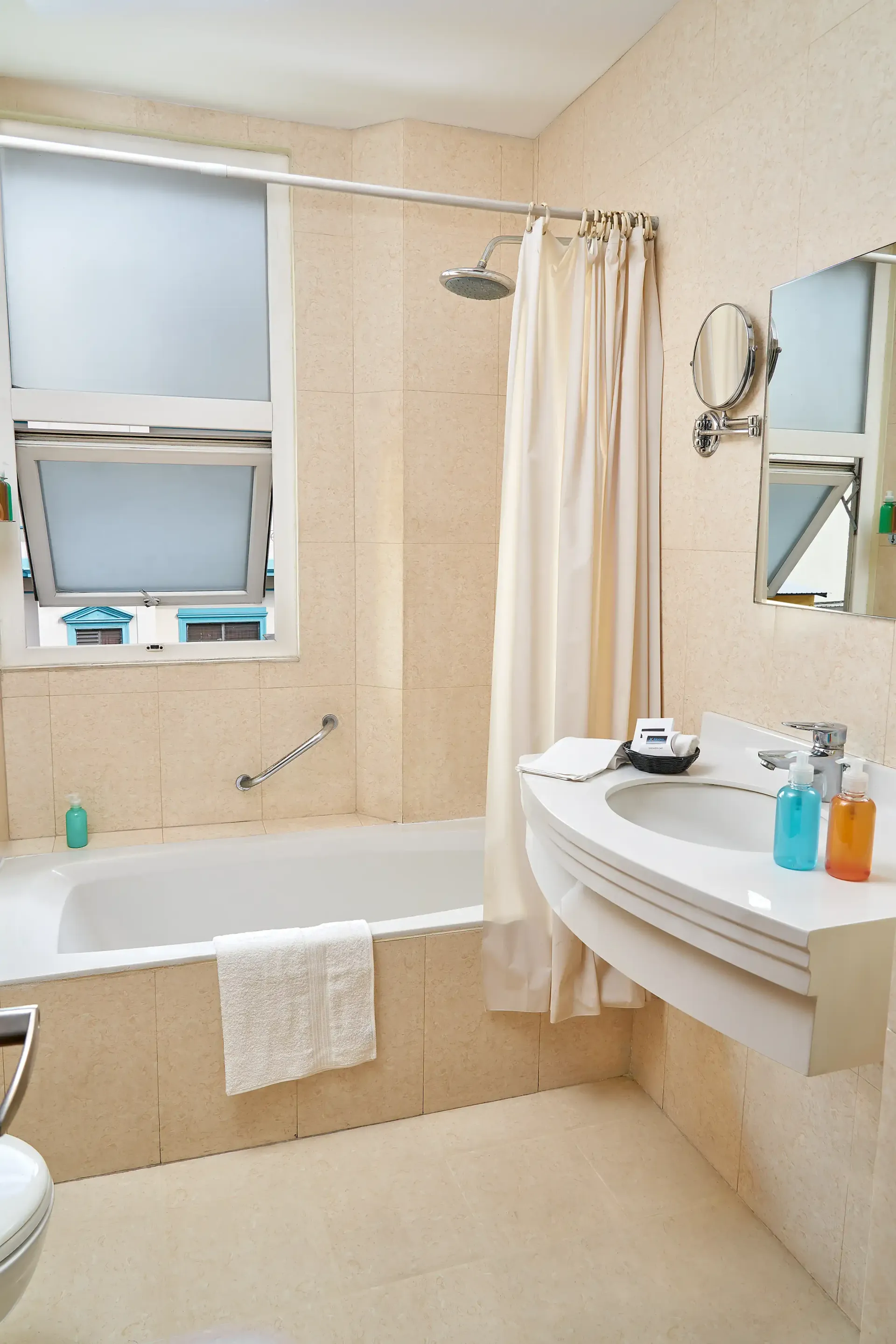 A bathroom with a tub a sink and a mirror