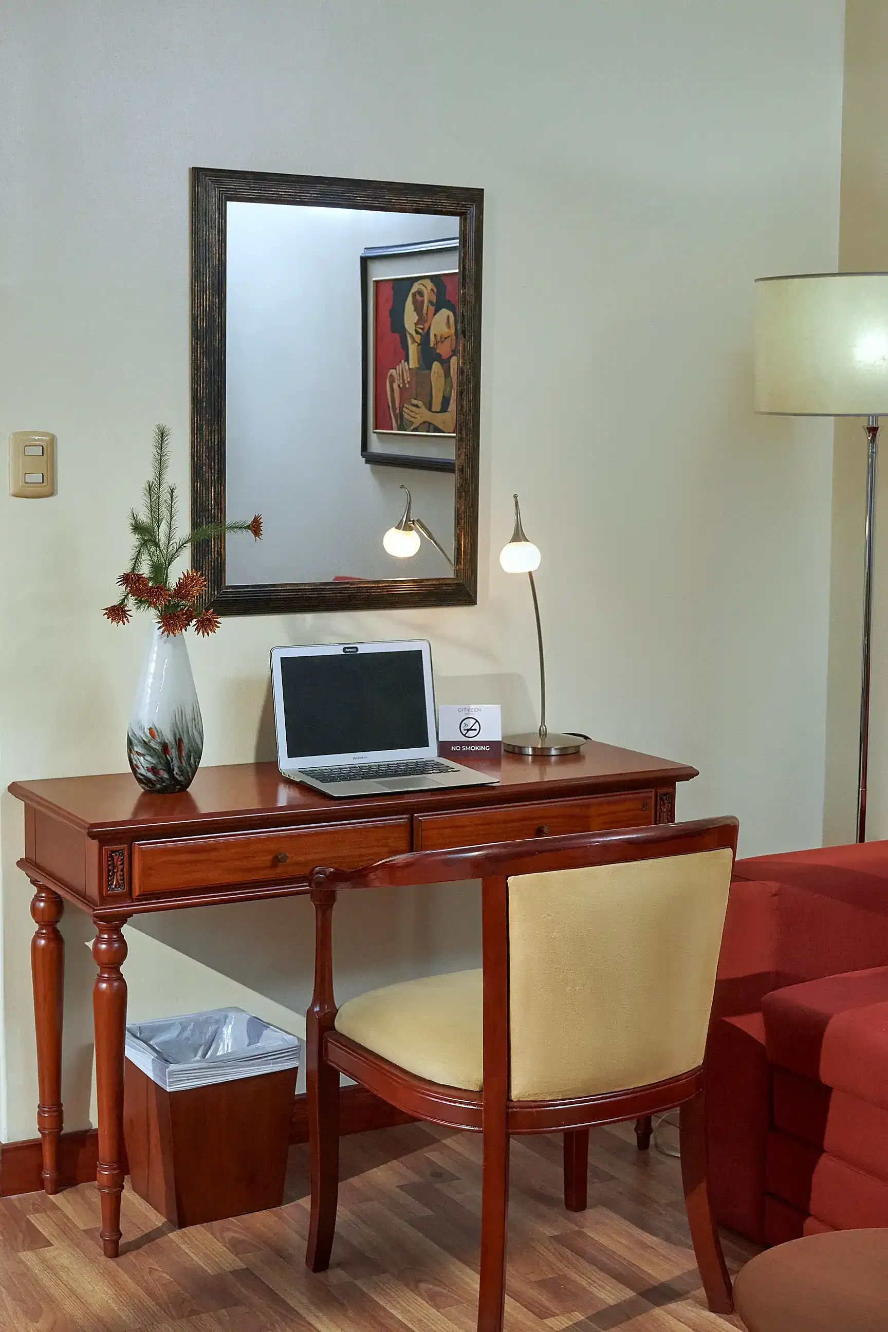 A desk with a laptop on it in a living room