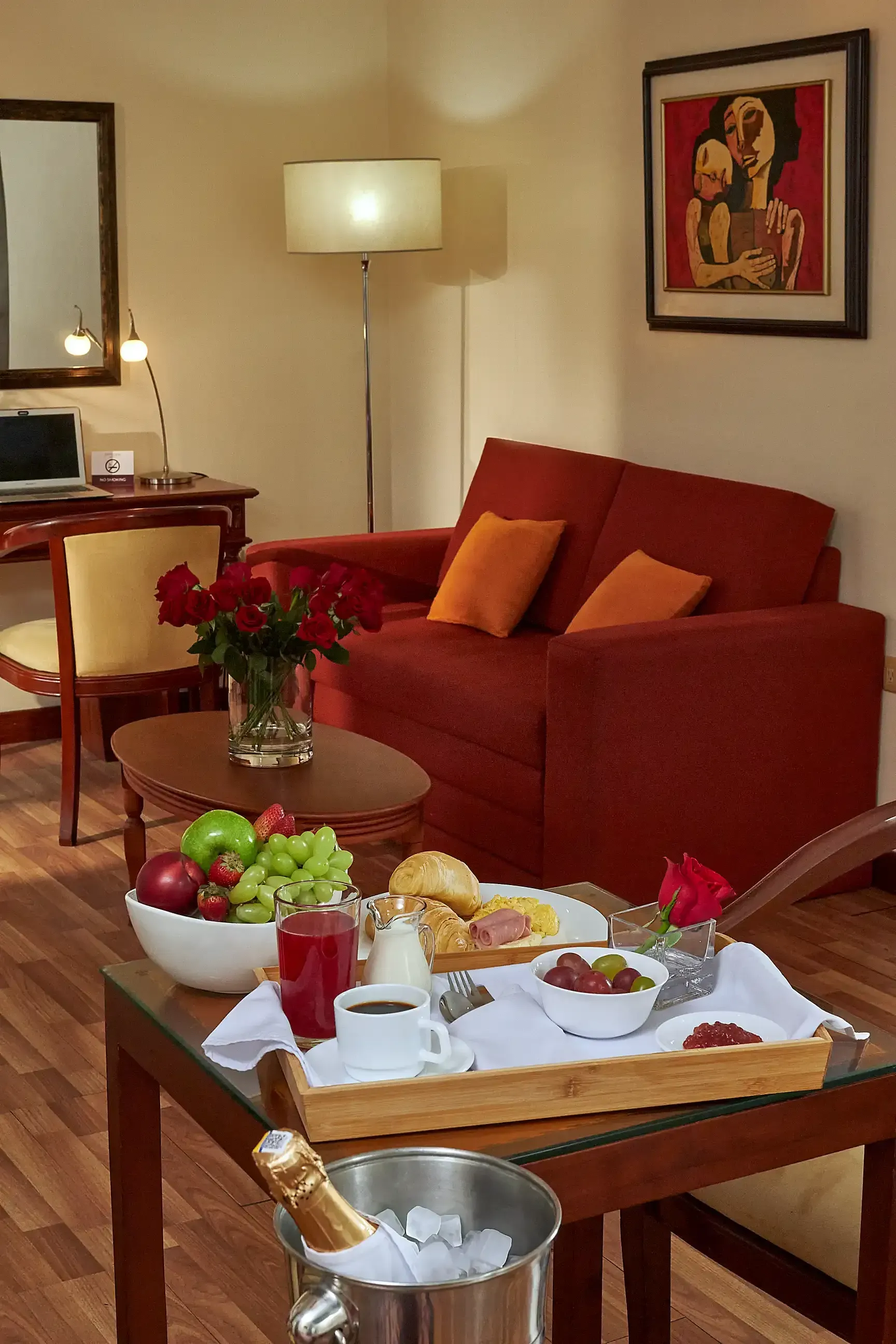 A living room with a tray of food and a bottle of champagne