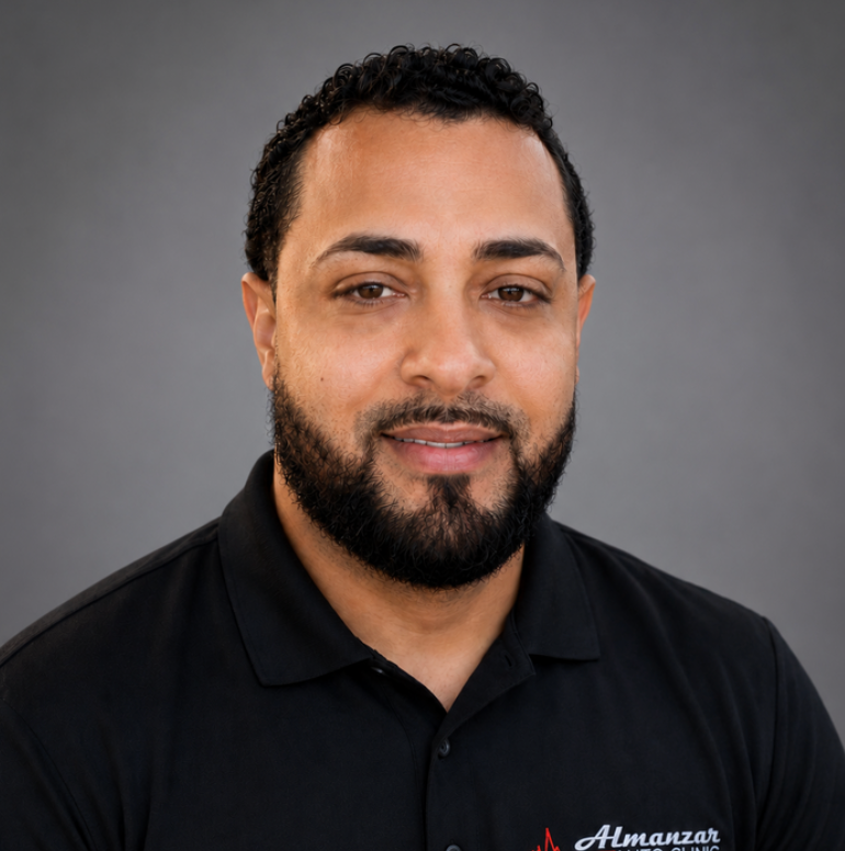 Portrait of a man in a black polo shirt against a gray background