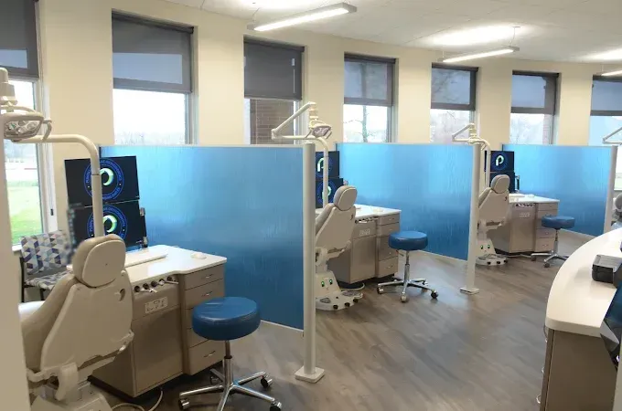 Orthodontic treatment chairs and blue privacy dividers at the Crown Point office