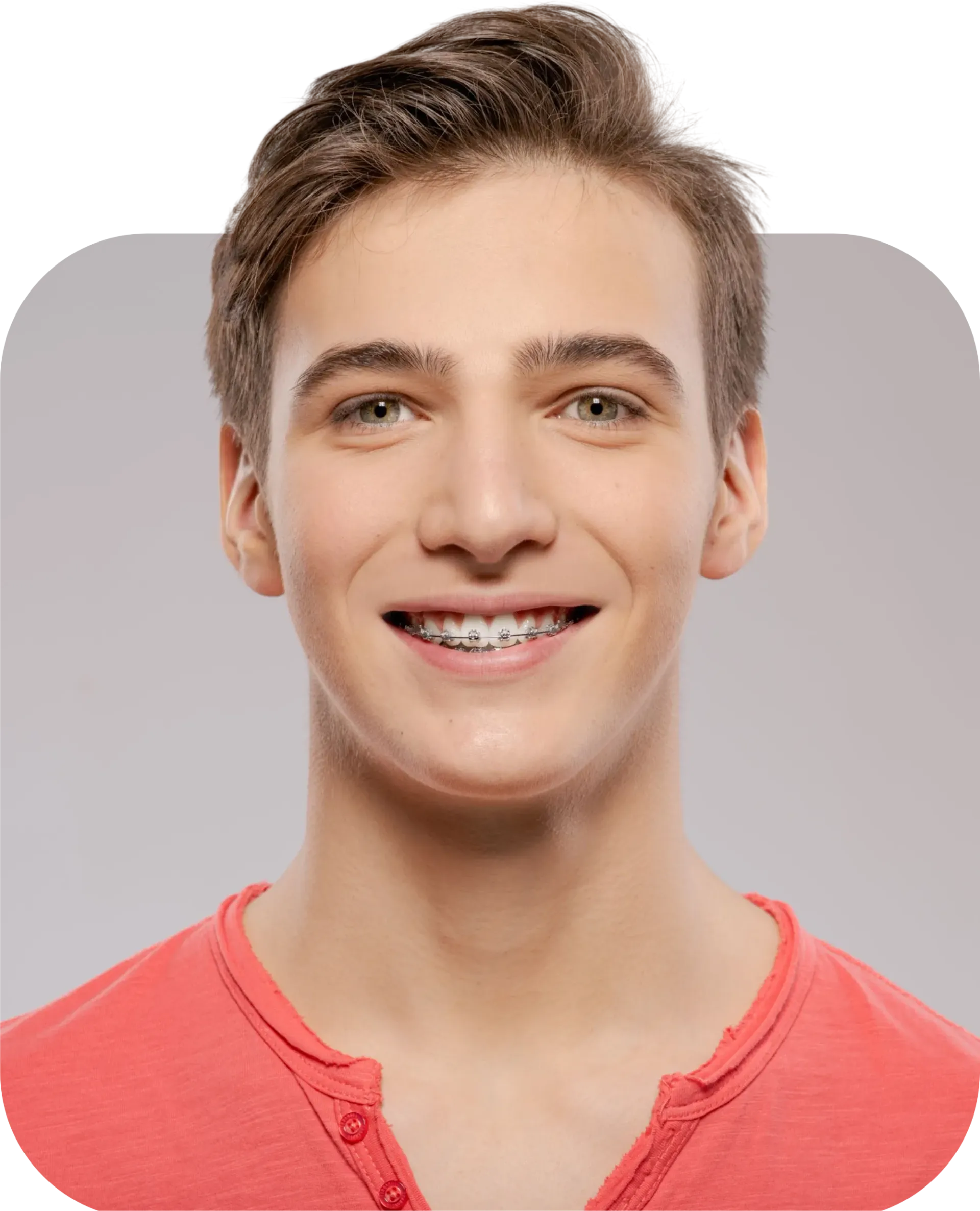 A young man wearing braces is smiling for the camera.