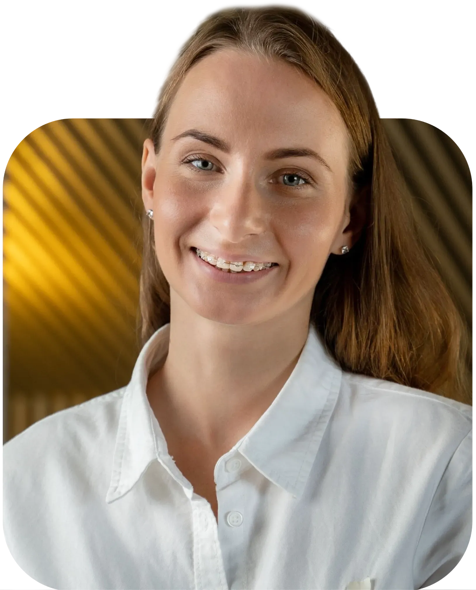 A woman in a white shirt is smiling for the camera
