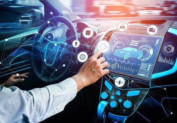 Person interacting with a futuristic car dashboard, with digital interface and blue highlights. | Morin Brothers Automotive