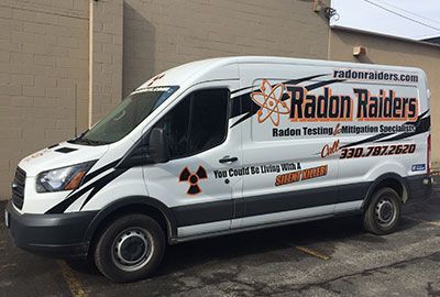 A White Van is Parked in Front of a Building - Youngstown, OH - Radon Raiders