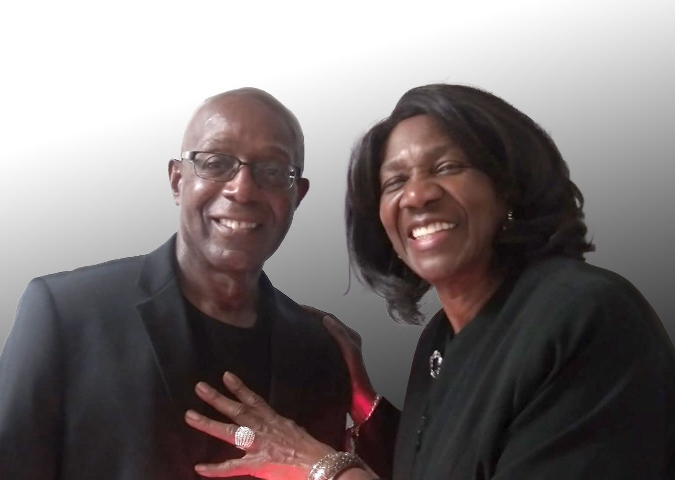 A man and a woman are posing for a picture and smiling