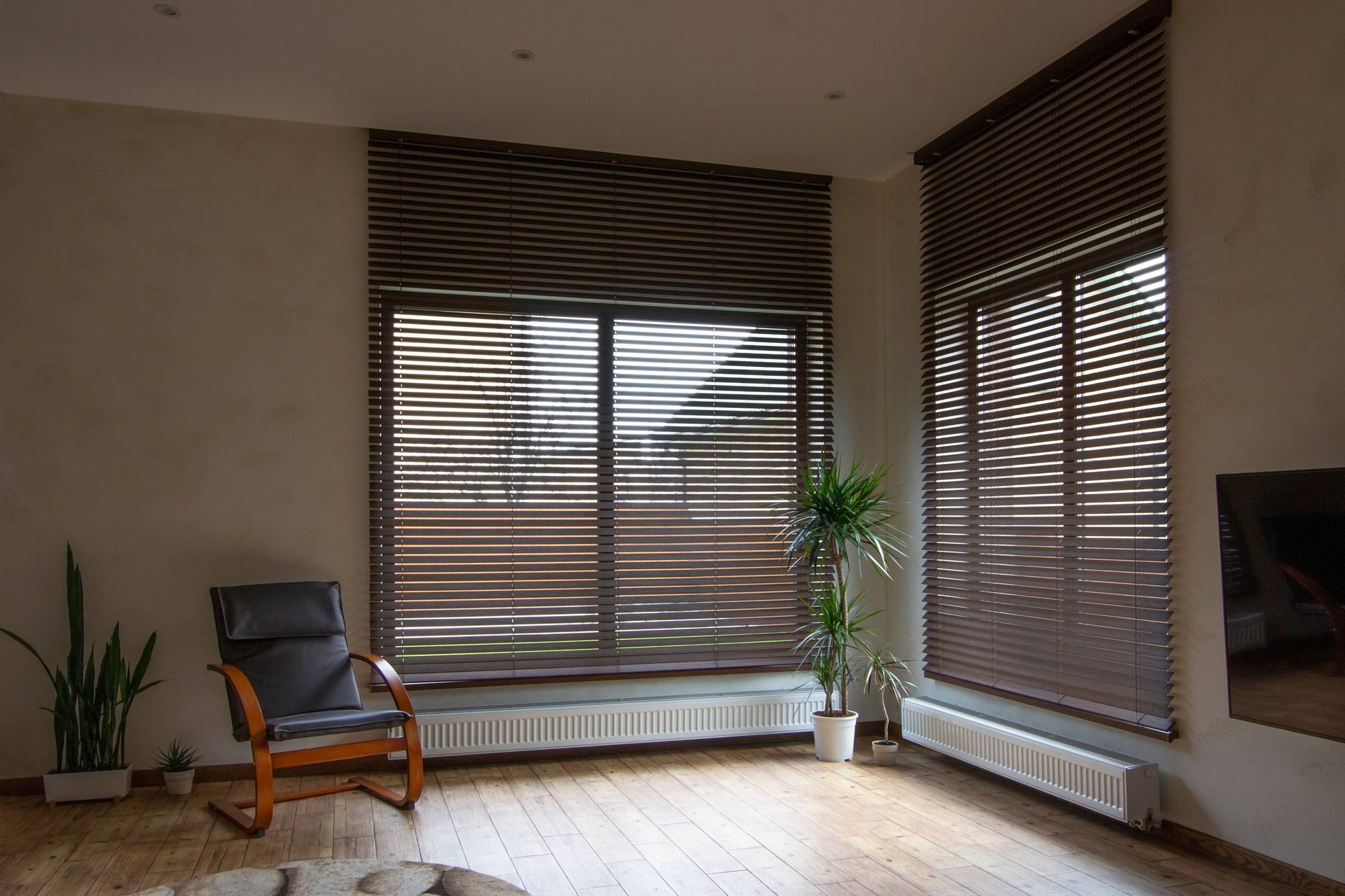 Brown blinds covering two windows in a living room at NH Blinds near Manchester, NH
