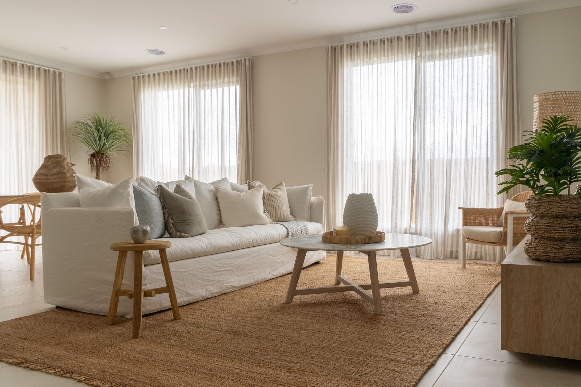 Coastal living room with beachy furniture and flowing custom drapery.