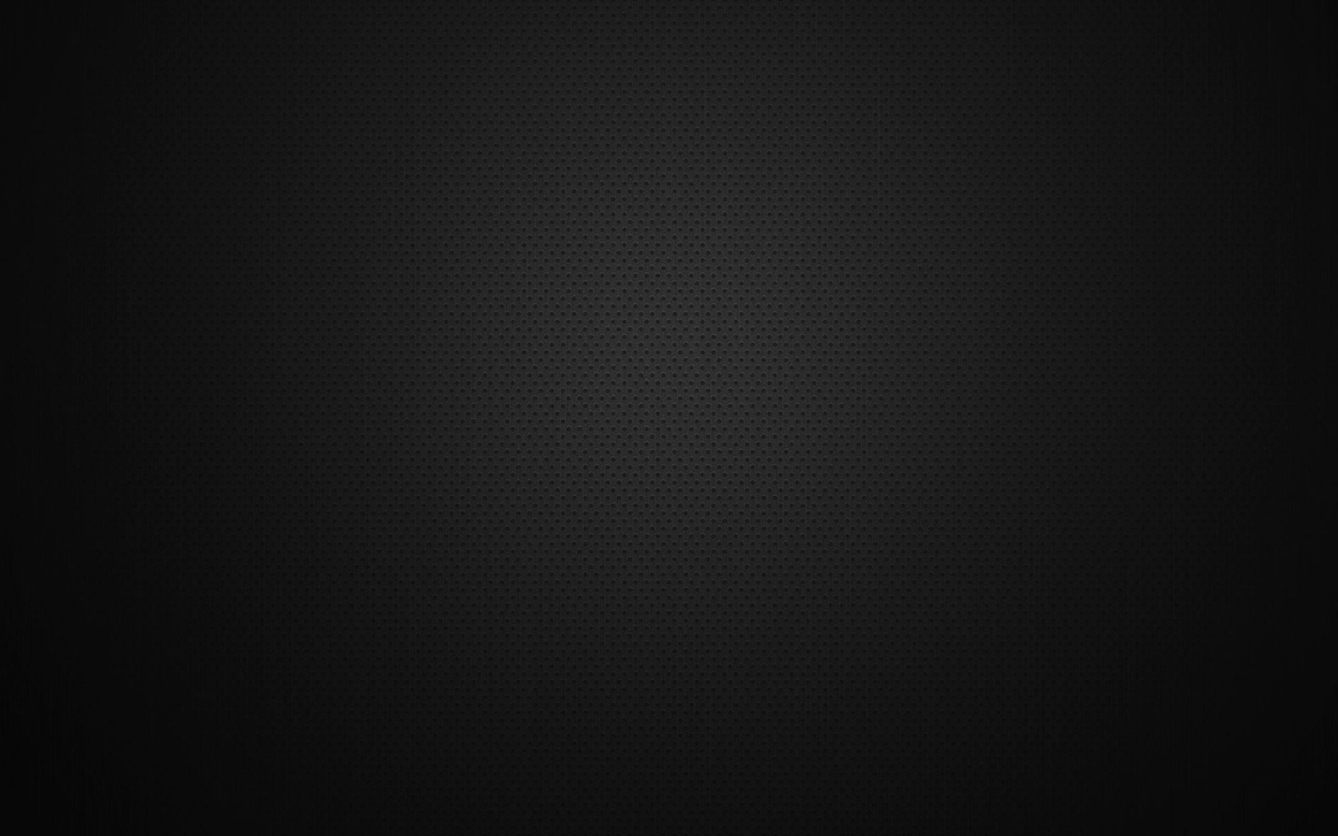 Dark, nearly black textured background with a subtle spotlight glow near the top center