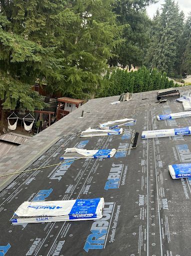 A roof with a lot of roofing material on it.