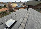A roof with a skylight and a chimney on it.