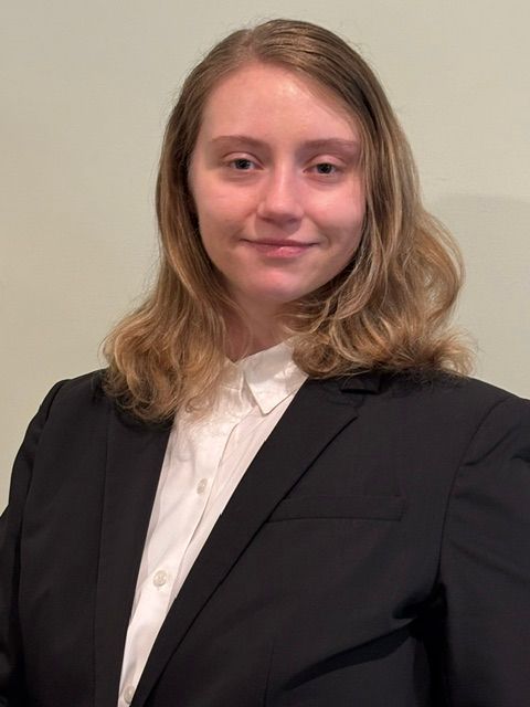 Woman smiling in a dark suit
