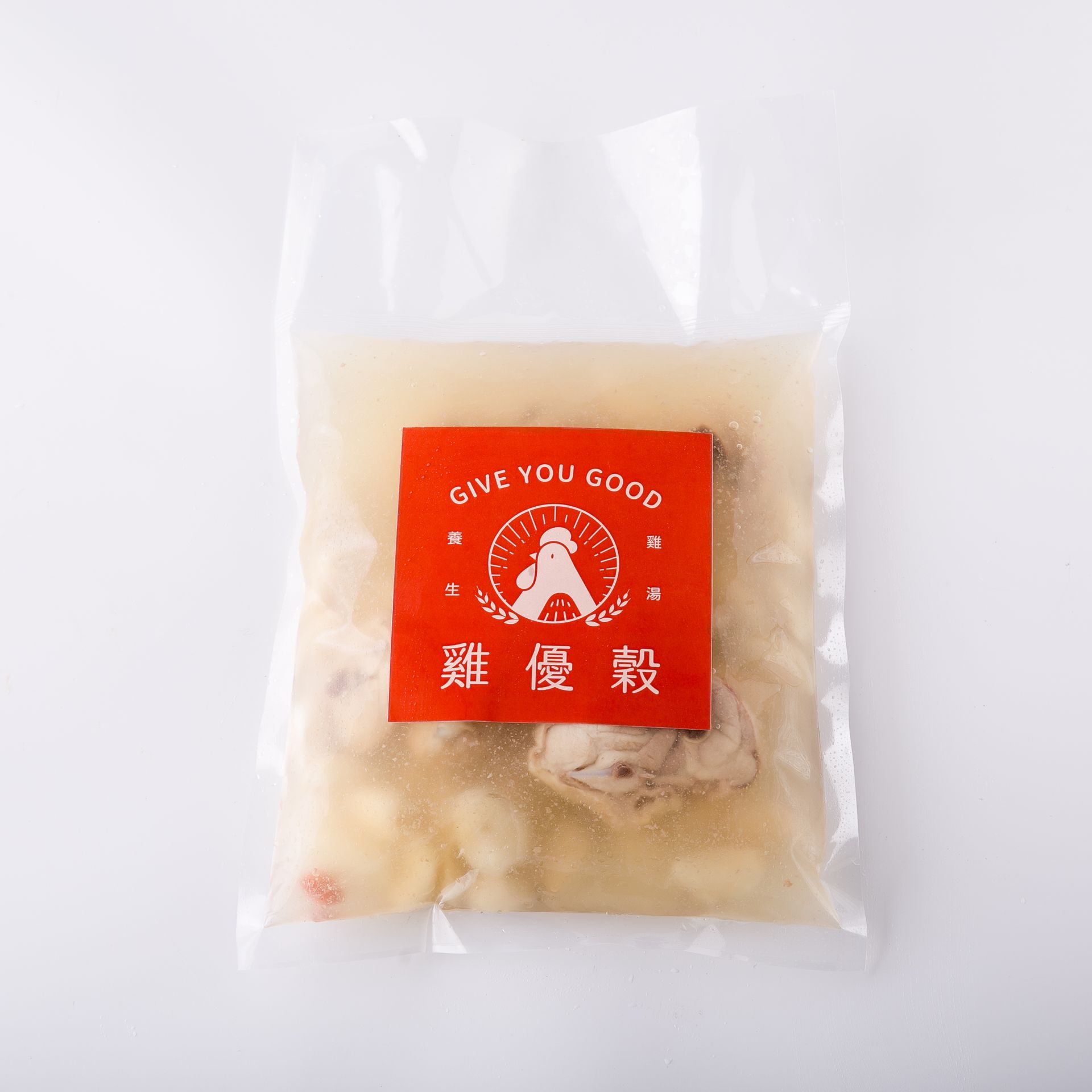 從上方俯視,可以看到盛在白碗裡的去皮蒜瓣和煮熟的肉,肉湯中浸泡著肉。