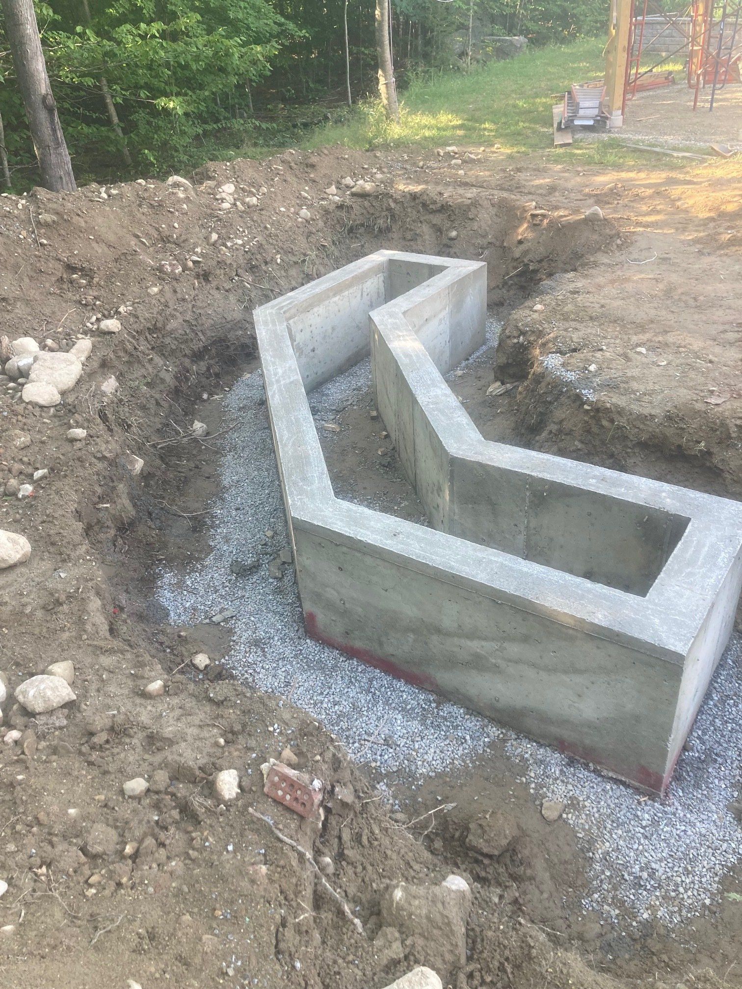 A large concrete block is sitting in the middle of a dirt field.