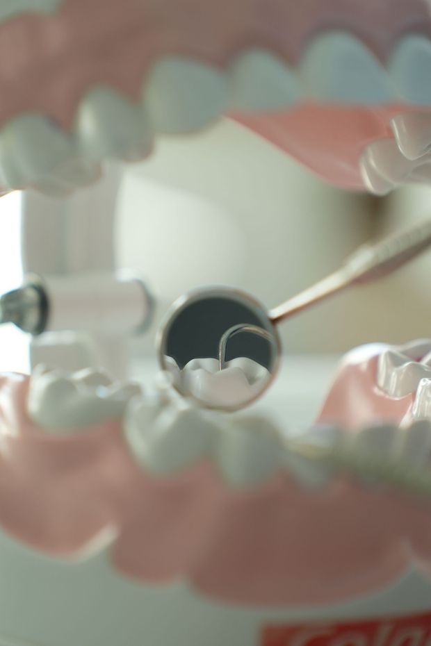 Close-up of clear and pink dental aligner trays with a black circular object in the center