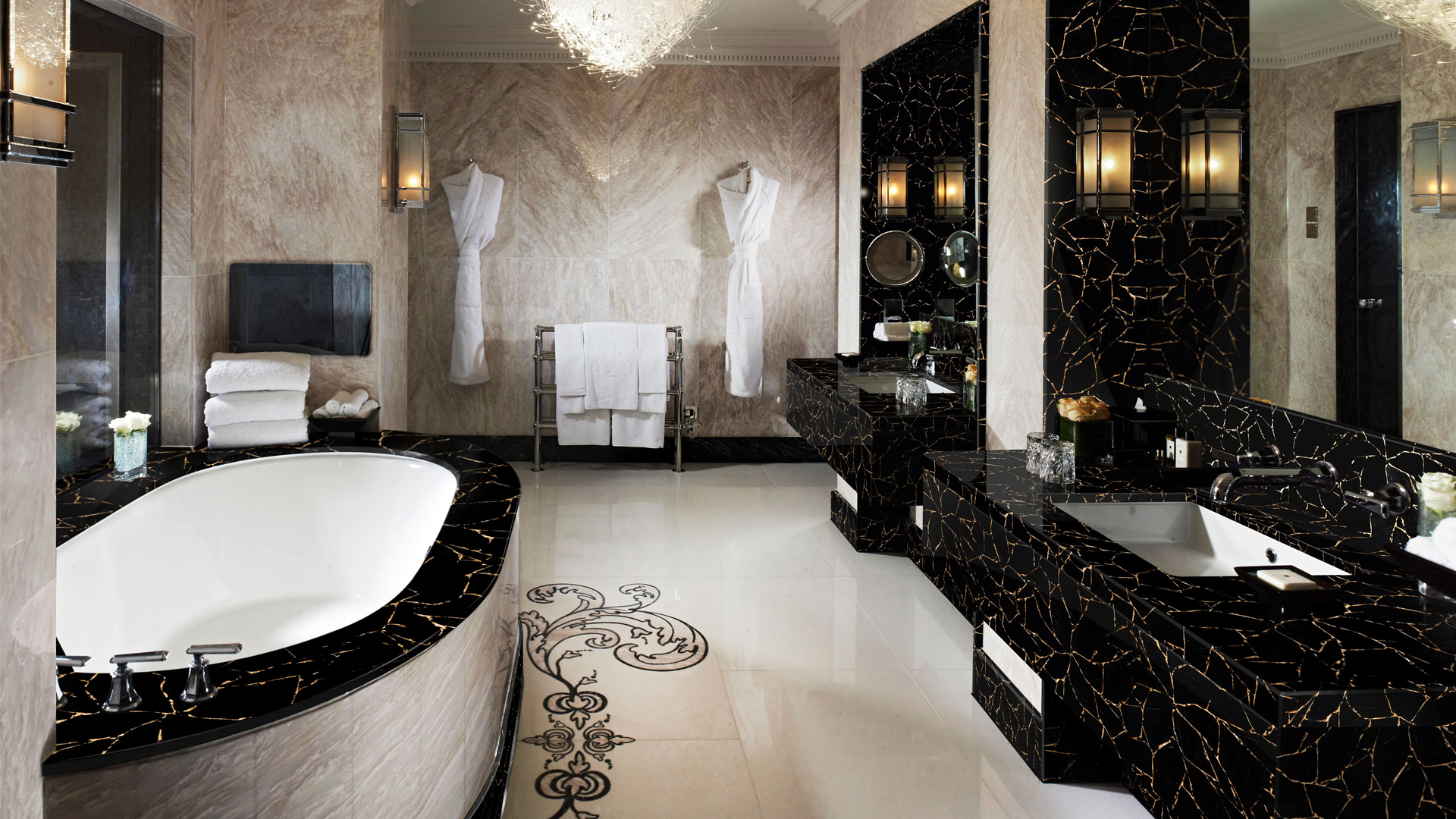 Luxurious bathroom with black and white marble finishes, soaking tub, and double sinks.