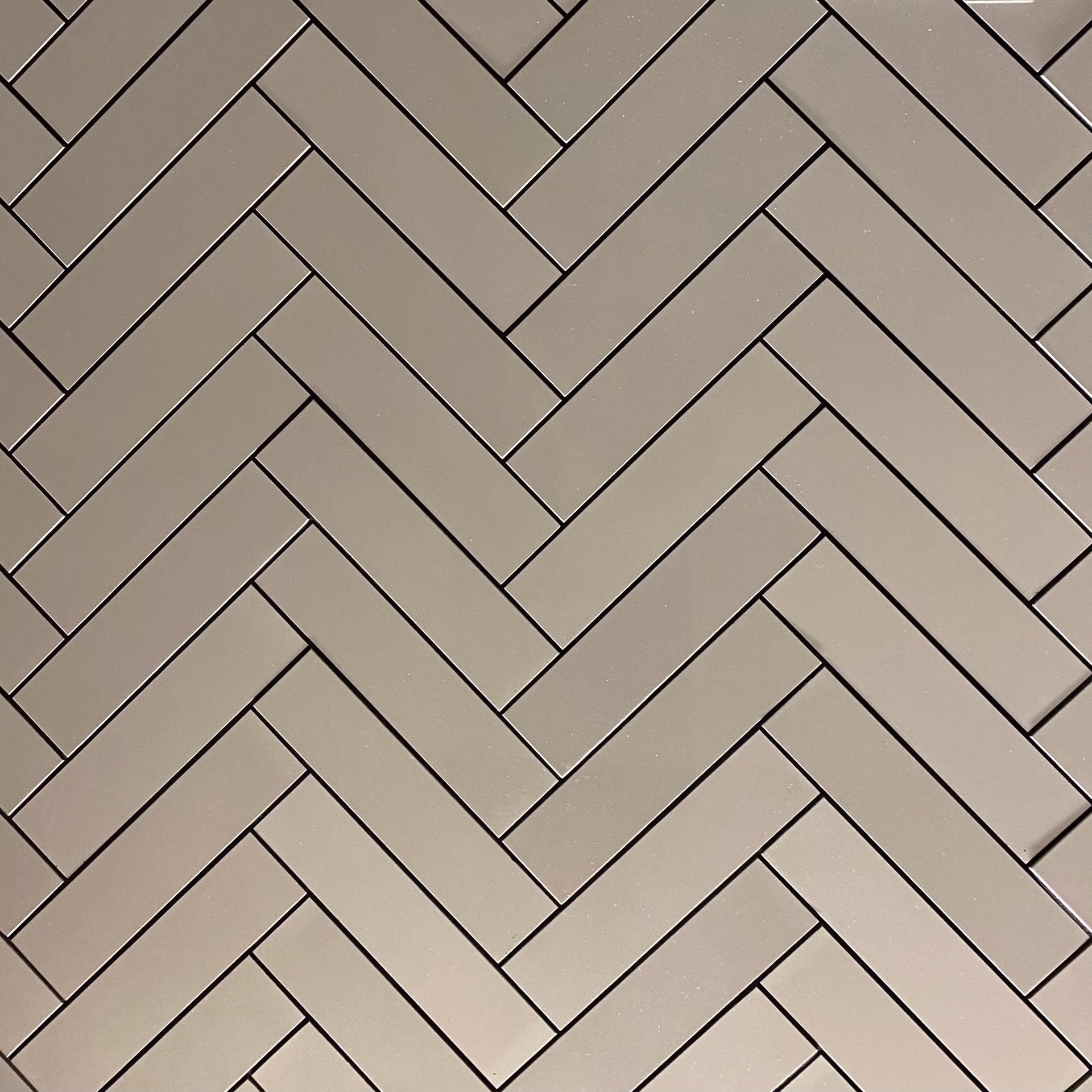 Herringbone tile pattern in shades of gray.