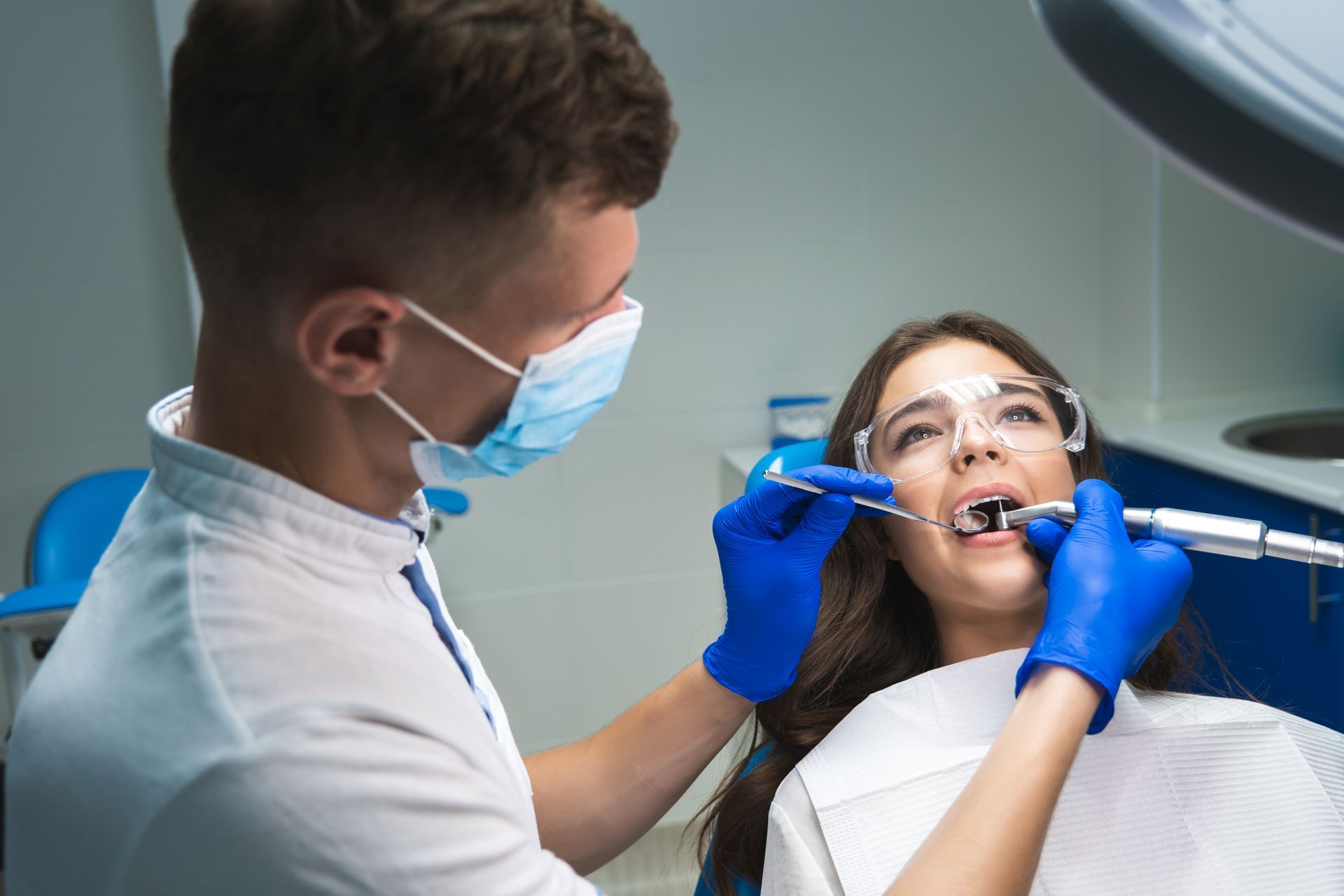 Dentist performing a root canal procedure on a patient.
