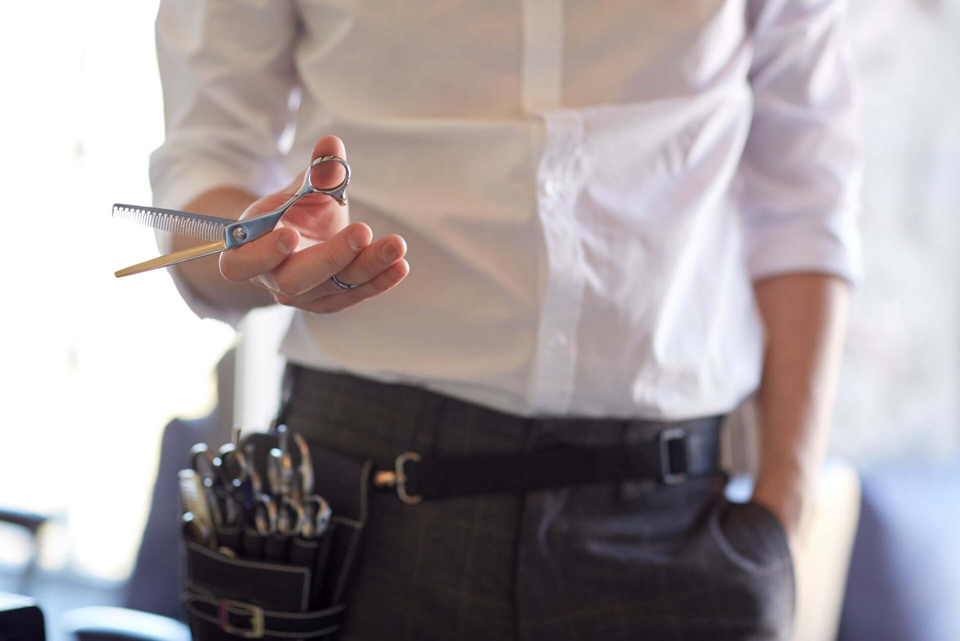 A man holding scissor — Honolulu, HI — Hawaii-Kai Barber & Styling