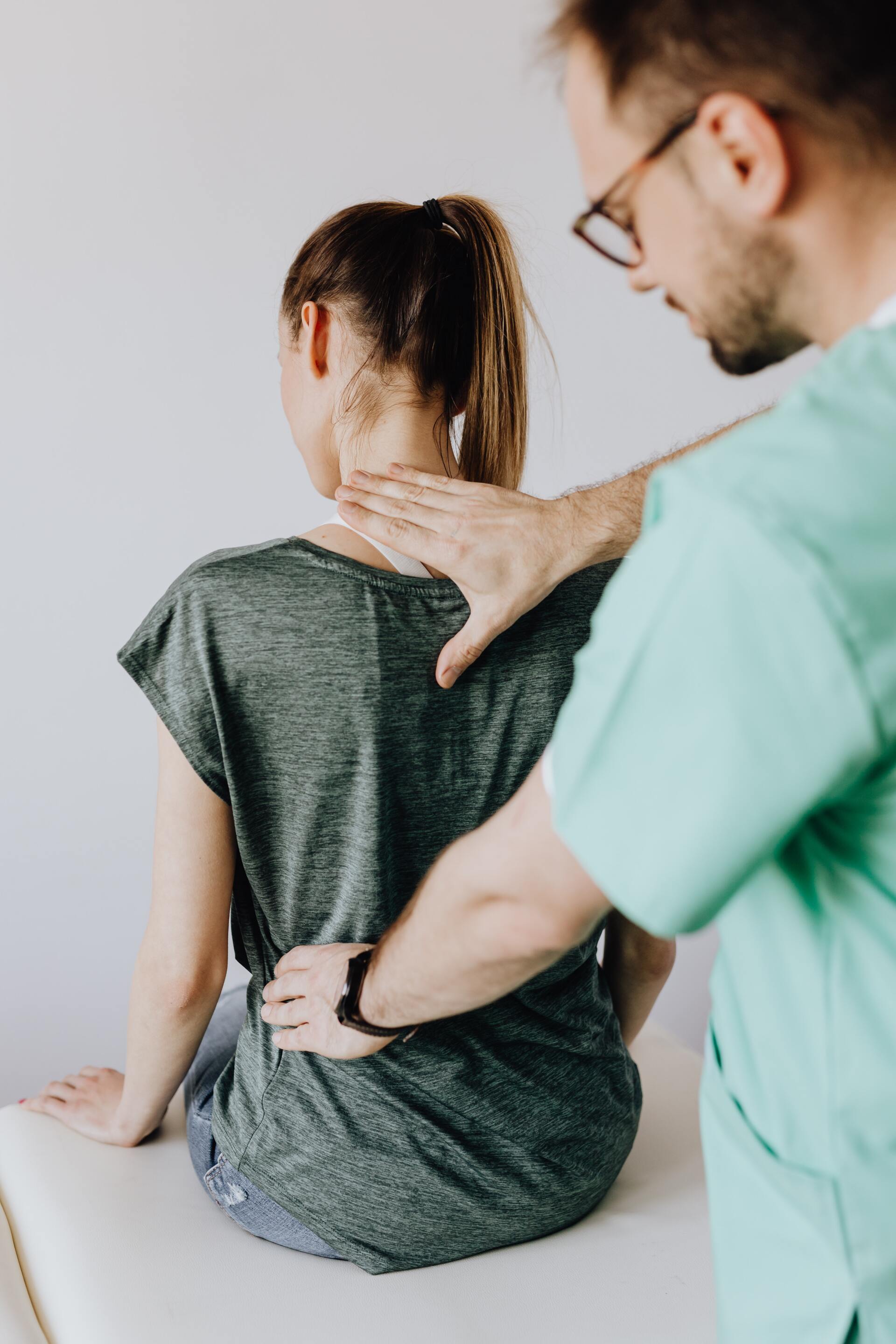 A man is giving a woman a massage on her back.