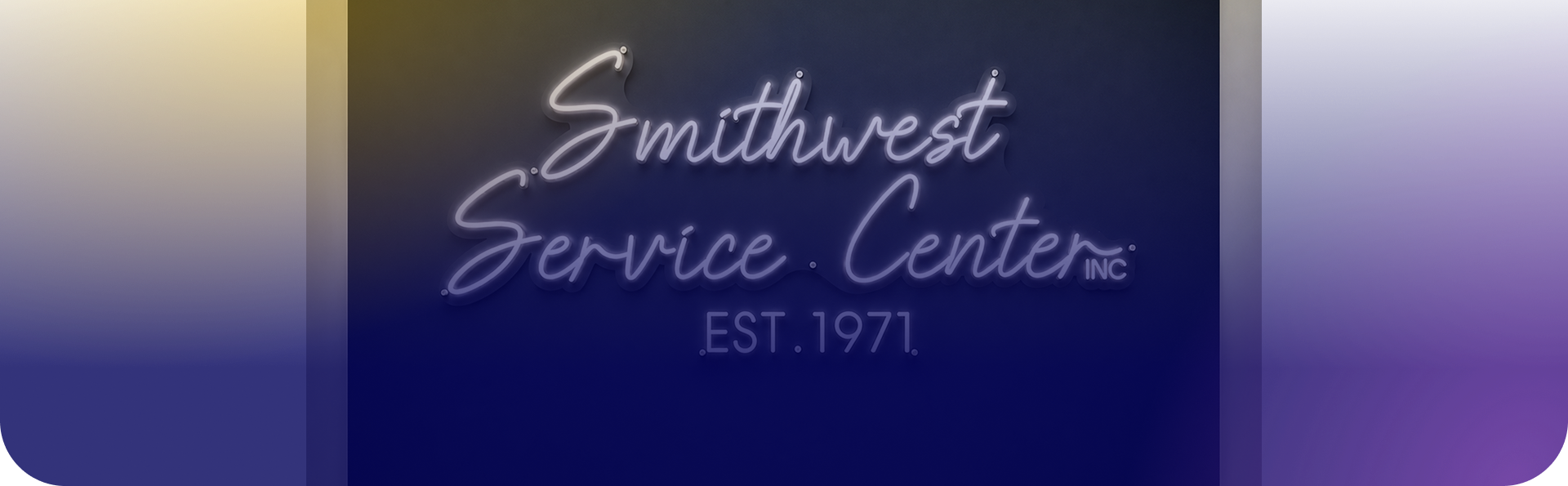 Reception desk at an auto repair shop with a fish tank, computer monitors, and informational signs on the walls. | Smithwest Service Center