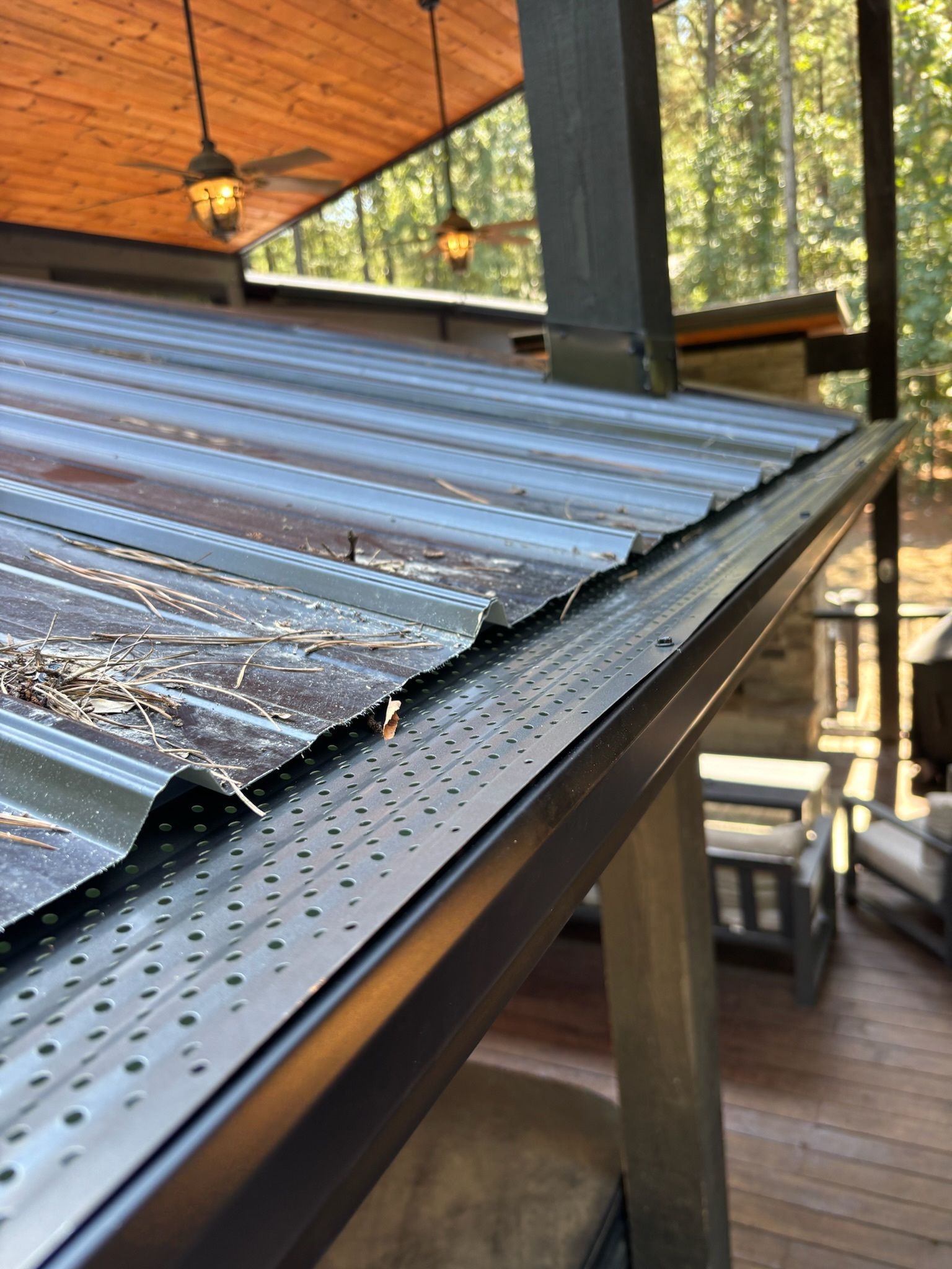 A close up of a roof with a gutter on it.