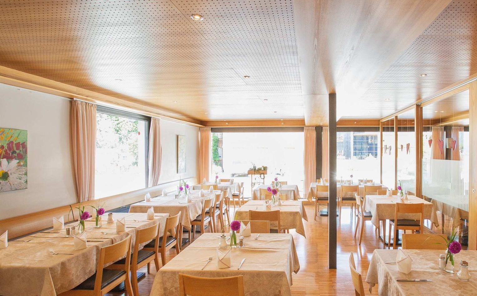 Restaurantbereich mit Tischen und Stühlen.