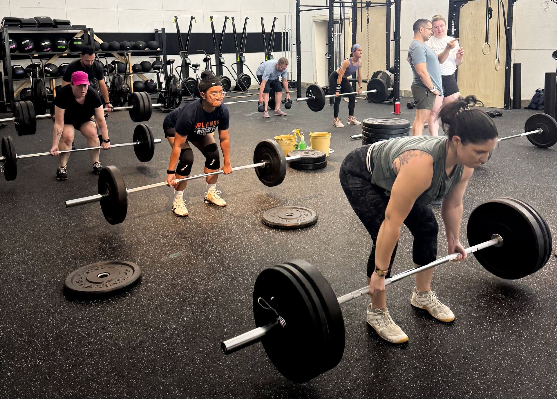 Members participating in a beginner-friendly CrossFit class at All Inclusive CrossFit in Winter Park, modifying movements in a supportive, judgment-free environment.