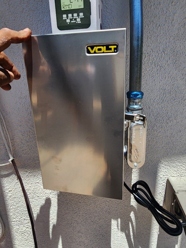 Wall-mounted VOLT metal electrical box with a plug and clear inline device on the right side.