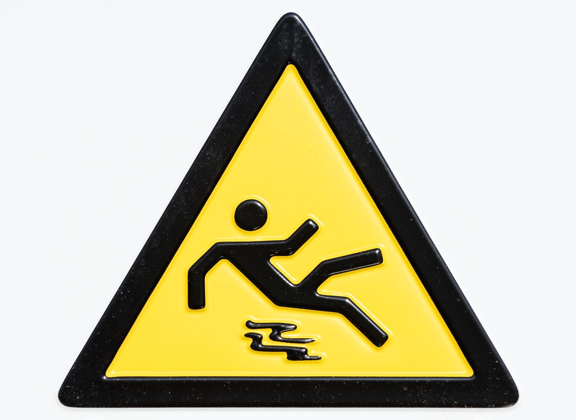 Yellow warning triangle with a slipping person icon on a black border