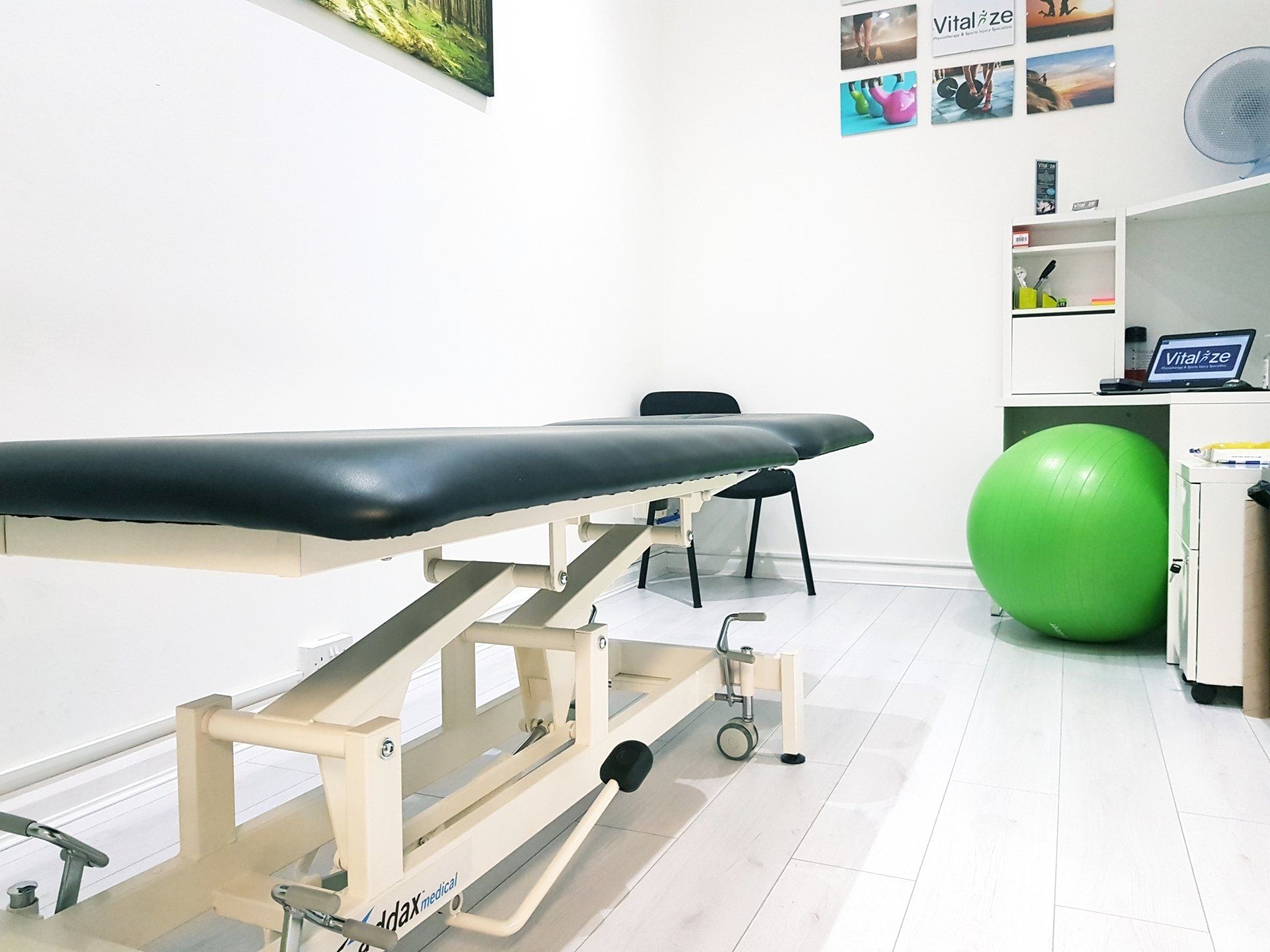 There is a green exercise ball in the middle of the room.